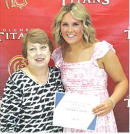 Kenadie Carter received the LaFerla Ortho Scholarship in the amount of $1,000 from USD 493 Instructor, Karen Langerot, during the 2025 Senior Assembly at the Columbus Unified High School Gymnasium, May 16.