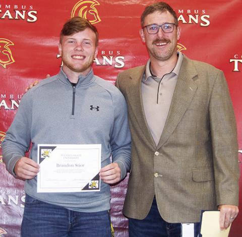 Brandon Stice received three scholarships from Wichita State University during the Columbus Unified High School Senior Assembly, May 16, at the CUHS Gym. He was awarded the Stucky Business Scholarship for $21,256, the Morrison Mer-it Scholarship for $14,000, and the DSI Semi-Finalist Scholarship for $4,000. Matt Crain, USD 493 Instructor, presented the awards.