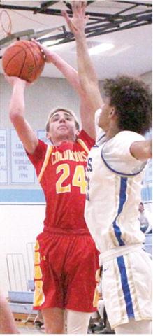 Kooper Saiz, Titan Sophomore, goes up against a towering, Terryk Richardson, Riverton Senior, on his way to scoring 17 points for Columbus in their first round Lancer Classic loss, Monday, in Cherokee.