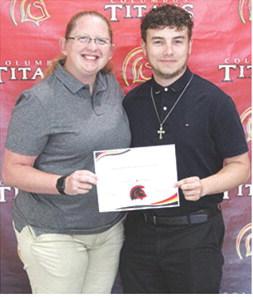 Senior, Owen Prauser, received two scholarships from Northeastern Oklahoma A&amp;M College at the Senior Assembly, May 16, in the CUHS Gymnasium. He received a Choir Scholarship in the amount of $5,000 and a Band Scholarship for $6,000 dollars from the NEO Music Department. Presenting the scholarships was CUHS Assistant Instrumental Director, Christine Lovell.