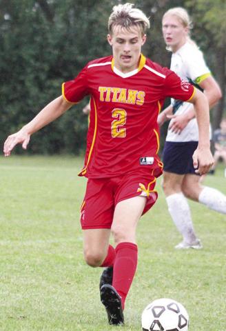 Titan Senior, Korbyn Newberry, controls the ball during the varsity soccer match against Liberty Home School, Monday, at the Central School Soccer Pitch.