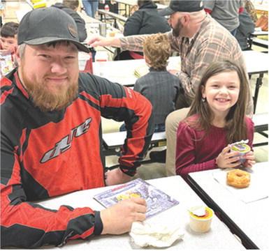 Ryan Clark joined Summer Clark at Park Elementary recently for their Books and Breakfast event. Friends, family members and older students joined the elementary classes to read a book or two and have breakfast. Courtesy photo.