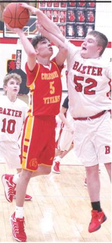 Titan Seventh Grader, Hayden Kellogg, goes in for two of his ten, fourth quarter points to help elevate Columbus over their Baxter Springs hosts, 31-25, Monday. Lion Jaydan Biddle tries to defend the shot and Carsyn Kelly trails.