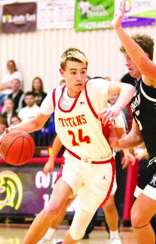 Kooper Saiz, Titan Sophomore, drives to the basket with a little push from his Frontenac defender in the January 31, home loss to the Raiders. The Titans lost a close one, 50-52, against St. Mary’s-Colgan, Friday in Pittsburg. Photo by Kristin Sharp.