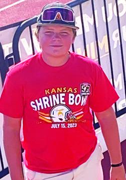 Columbus Titan Ethan Midgett has been ball boy and bat boy for his brother Landin’s ball teams for many years. Saturday was no different when the incoming CUHS Freshman was on the sideline serving as ball boy for the 50th Annual Kansas Shrine Bowl Game in Hays. Courtesy Photo.