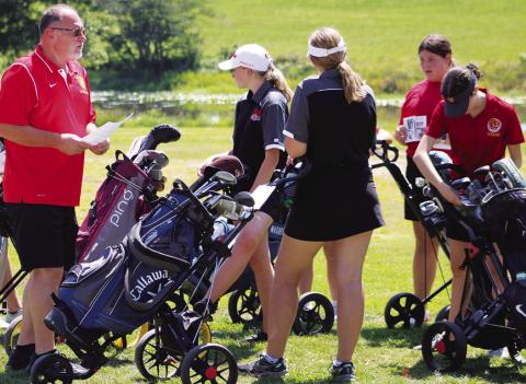 Lady Titan Golf Coach, Ernie Vaughn, meets with members of his team prior to tee off at the Columbus Invitational Golf Tournament, Thursday, at the Brush Creek Golf Course in Columbus. The Lady Titan held off St. Mary’s-Colgan for the one stroke win. Mallory Thompson, Anna Head, Jaiden Campbell, and Natalie Wary prepare for the day.