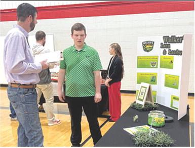 The annual Youth Entrepreneurship fair was held yesterday at Baxter Springs High School. Brooks Walker discussed his landscaping business with judge Mike Evans. Courtesy photo.
