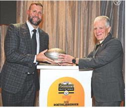 Ben Roethlisberger receives his commemorative football from Steelers President Art Rooney II upon his selection into the Steelers Hall of Honor Class of 2025. Roethlisberber joins linebacker, Joey Porter Sr. and center, Maurkice Pouncey. The ceremony took place over the weekend at Acrisure Stadium in Pittsburg. Courtesy photo Steelers.com.
