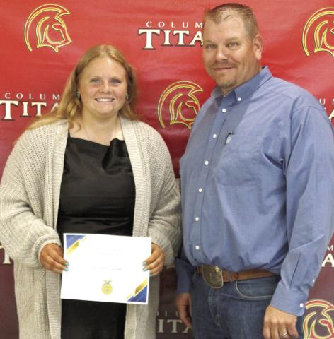 Madisen Rand received the MFA and National FFA, Scholarships for $5,000 from Columbus High School FFA Advisor, KC Youngblood, during the 2025 Senior Assembly, May 16, at the CUHS Gymnasium.