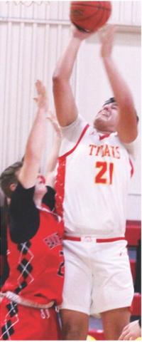 Titan Senior, Rece Ponce, went up for two points over his Baxter Springs opponent, in the 38-60, Titan loss to the Lions, Friday, at the Columbus Unified High School Gymnasium.