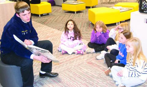Columbus High School FFA member, Trenton Lacen reads to Amyx Evans, Taylynn Midgett, Brynn Bownan, Harley Sherrill and Adeline Salas, Caitlin Creech’s third graders at Central Elementary. Reading took place at the Central Elementary library as part of national FFA week. News Report photo by Tanya Woolsey.