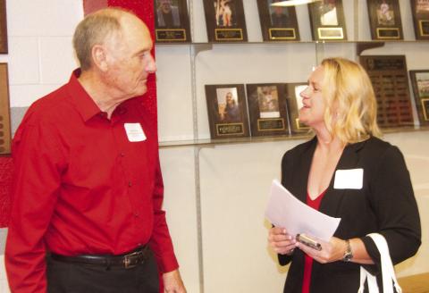 Baxter Springs coach Don Karnes talks with Hall of Fame inductee Pam Brewer-Hunt at the ceremony on Saturday night. Karnes described her as having all the qualities of a basketball point guard.