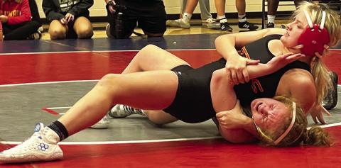 Emily Britt, Lady TItan Junior, pins her opponent during action at the Bentonville West High School Tournament, Friday, in Centerton, Ark. Emily placed third in the 135-pound weight class Photo courtesy of Amanda Stone.