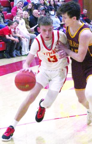 Titan Sophomore Point Guard, Carter Woodcock, makes his way to the basket with the “aide” of Girard Sophomore, Perrin Stevens, during the Columbus varsity loss to the Trojans, Tuesday, at the CUHS Gymnasium. Carter had 15 points in the 54-52 loss to Colgan, February 7 in Pittsburg.