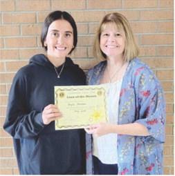 Brylie Johnson was recently presented a certificate recognizing her as the Lion of the Month for May. Regina Jameson presented the award.