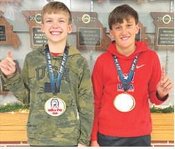 Lucas Natalini, 12U, 95B, and Briggs Johnson, 12U, 100B, took first place in their respective age/weight classes at the Seneca, Mo. Youth Open Tournament, December 7. Lucas got two quick falls before winning a 5-3 decision in the championship match. Briggs won his first match by fall then earned technical falls in the semi-final and championship matches. Courtesy photo.