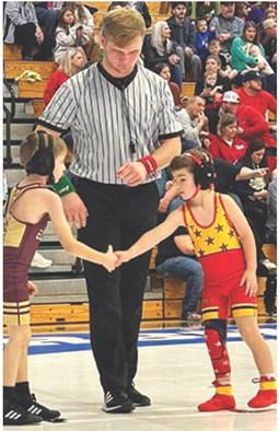 Rhett Tedlock shakes the hand of his opponent after getting a win during the Marshfield, Mo., Holiday Championship Tournament, Saturday. Rhett also wrestled in Erie Red Devil Tournament, December 17. The Columbus Wrestling Club will be in Anderson, Mo. tomorrow. Courtesy Photo.