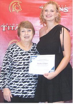 Hailey Ediger received two scholarships from Hutchinson Community College to play softball during the Columbus Unified High School Senior Assembly, May 16, at the CUHS Gymnasium. She received $4,052 books, tuition, and fees scholarship and $2,000 housing scholarship from presenter, Karen Langerot, USD 493 Instructor.