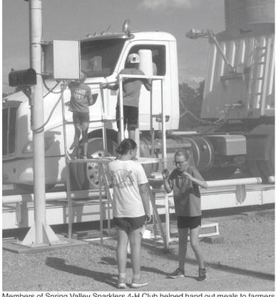 Members of Spring Valley Sparklers 4-H Club helped hand out meals to farmers at Coop Thursday.