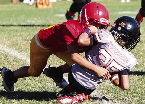 Briggs Johnson makes a tackle in the backfield during the Titan 3rd/4th Grade loss to Independence, 8-22, Saturday at Titan Stadium. Photo by Kristin Sharp.