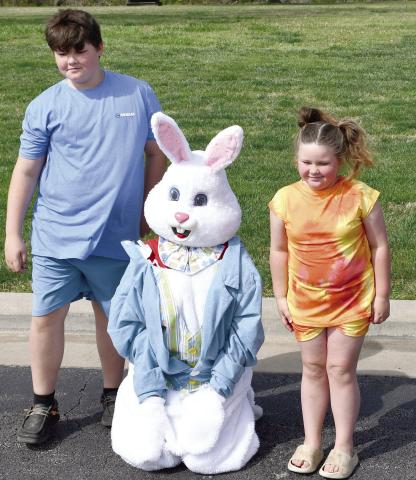 Visiting with the Easter Bunny Corbin and Chole Lake were among the hundreds of youngsters at the Baxter Springs High School. The hunt is sponsored by the Baxter Springs Kiwanis Club. The event was held Saturday at the Junior High and High School complex. Photo by Greg Hiatt.