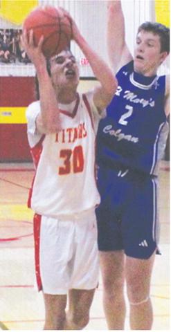 Drake Laurance, Titan Sophomore, shoots for two in the home opener against St. Mary’s-Colgan, Friday, at the CUHS Gym. Colgan Junior, Brady Crossland, defends the shot in the Panther win, 66-30.