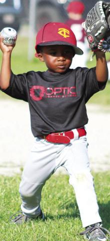 Miles Reeves warms up his throwing arm and Josh Lacen gets a hit during the Columbus Cal Ripken League Tee-ball games 