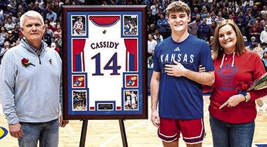 Patrick Cassidy and his parents Jeff and Julie Cassidy during the Kansas University Senior Night Ceremonies, Tuesday, at Allen Fieldhouse in Lawrence. The academic senior will use his available eligibility to continue his career with the Jayhawks next season. (Courtesy Photo.)