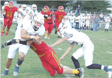 Titan Junior, Korbyn Newberry, takes down Galena Senior Zane Turner, in the backfield as a host of Titans converge on the play. Bulldog Junior, Kota Dannels, tries to assist Turner to no avail. Columbus earned their first win over Galena, 12-8, Friday night at Titan Stadium.