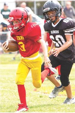 Columbus Mini Titan, Bodie Saiz, broke tackles as he scored the final touchdown of the third and fourth grade Titan win over Frontenac, 30-0, at Titan Stadium, Saturday. Photo courtesy Kristin Sharp.