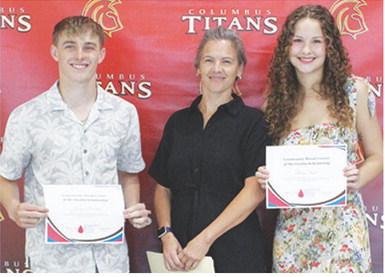 Korbyn Newberry and Ruby Stover received Community Blood Center of the Ozarks Scholarships in the amount of $150 each from USD 493 Instructor, Brandy Pierce during the 2025 Senior Assembly, May 16, at the Columbus Unified High School Gymnasium.