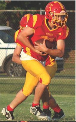Titan Junior, Shade Schuberger, (left) had a long run inside the fiveyard line before being brought down by the Bulldog defender short of the goal line. A penalty and lost yardage kept Columbus out of the end zone during the Titan Junior Varsity loss to Galena, 0-24, Monday, at Titan Stadium.