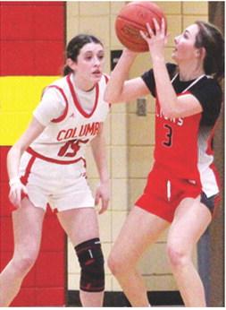 Junior, Kierstan Burggraf, scored eight of the Lady Lions, 12 points, in their Friday night loss to the Lady Titans, 12-45, in Columbus. Sophomore, Natalie Wary defends for the home team.