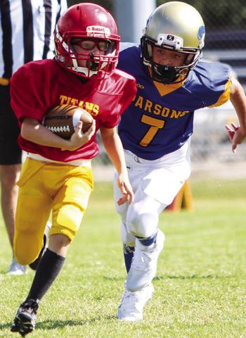 Mini Titan Dayton Hughes scored two touchdowns in Saturday’s third and fourth grade loss to Parsons, 12-26, at Titan Stadium. Photo by Kristin Sharp.