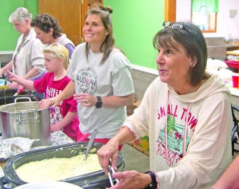Volunteers were all smiles as they served the Community Christmas dinner Saturday afternoon. Diners were treated to turkey with all the fixings as they visited with friends old and new.
