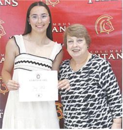 Torey Tedlock received the Wyandotte Nation Tribal Scholarship for $40,000 from USD 493 Instructor, Karen Langerot, during the 2025 Senior Assembly at the CUHS Gymnasium, May 16.