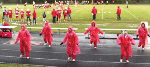 Kelsey Brown, Andi Johnson, Bella Fugate, Laylah Trejo, Lilly Weston, and Keely Barngrover, cheer on their Lions in the pouring rain during the last game of the season. Photo by Dee Riley.