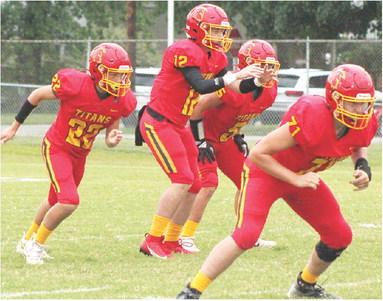 The Columbus Titan Offensive Backfield lined up for a play at Titan Stadium in a recent home game with sophomore, Jett Tanner at quarterback, freshmen, Trenton Lacen and Braun Stone as backs and junior, Kyler Rahmeier, offensive line. Columbus lost a tight, 12-14, battle in Galena, Monday night to the bulldogs.