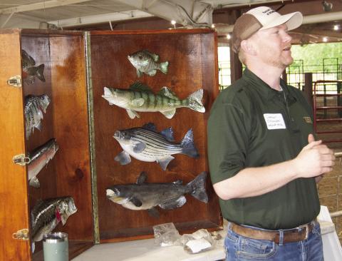 Kansas Department of Wildlife and Parks representative, Connor Ossowski presented the different fish found throughout Kansas at a recent Earth Day event for fourth and fifth graders. News Report photo by Tanya Woolsey.