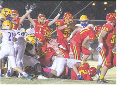 A host of Titans cheer on junior, Jett Tanner as he crossed the goal line from six yards out for the first six points of the 28-21, Columbus win over Parsons, Friday at Titan Stadium.
