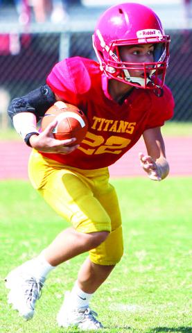 Blaze Bowman scored on a 35-yard run, a punt return, an interception return, and a pass play in the Columbus Fifth and Sixth Grade Titan win, 30-6, in Oswego, September 23. Photo by Kristin Sharp.