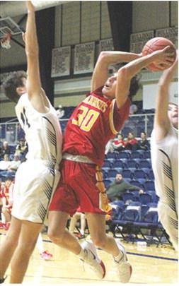 Titan Junior, Drake Laurance, fails to draw a foul against his Galena defenders on his attempted shot in the 29-58 loss to the Bulldogs in Galena, Tuesday.