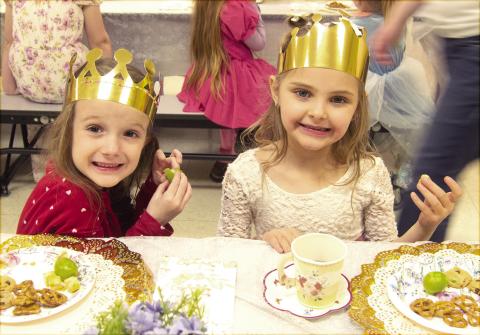 Park Elementary Kindergarteners dressed up and enjoyed a Royal tea party recently. PaisLee Stoner and Sadie Stradley, dressed as princesses, snacked on pretzels, cheese and grapes while having their tea. News Report photo by Tanya Woolsey.