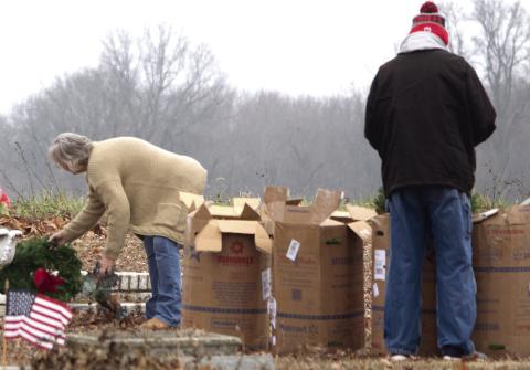 The fresh live wreaths arrived in several large cardboard boxes which were unpacked and taken to the individual grave sites.