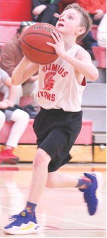 Columbus Fourth Grader, Lee Snow, goes up for a layup in the Recreation League win over Baxter Springs Youth Basketball, Saturday, at the Central School Gymnasium.