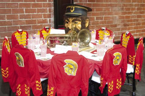 The USD 493 decorated table featured antique Titan Band uniforms as chair covers and the “Titan Man” along with some antique brass instruments.