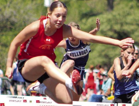 Lady Titan Brinleigh Meyer clears the hurdle during the Columbus Invitational, April 20, at the Central School Track. Thursday, she won the 100 Meter Hurdle event at the Frontenac Invitational with a time of 18.41 seconds and was a member of the 4x200 Meter Relay Team that also placed first at Frontenac. The Columbus seventh grader placed fifth in the 400M Dash and sixth in the 100M Dash.