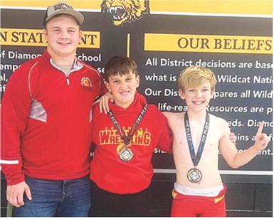 Columbus Wrestling Club Members, Trent Smith, coach; Briggs Johnson (second); and Lucus Natalini (first), participated in the Diamond Youth Open Tournament, Saturday in Diamond, Mo. Courtesy photo.