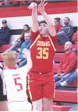 Titan Senior, Jett Tanner, makes one of his four, three-point shots to lead Columbus with 16 points in their 46-50 loss in Baxter Springs, Monday. Sophomore Logan Abbott defends for the Lions.