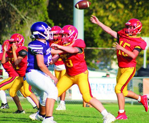 Titan Jex Cheney, and members of the seventh grade offensive line give quarterback, Jace Gaither, time to throw during the 28-34, Titan loss to Pittsburg, Monday, at Titans Stadium. The non-conference thriller ended in an overtime standoff won by the visiting Purple Dragons.